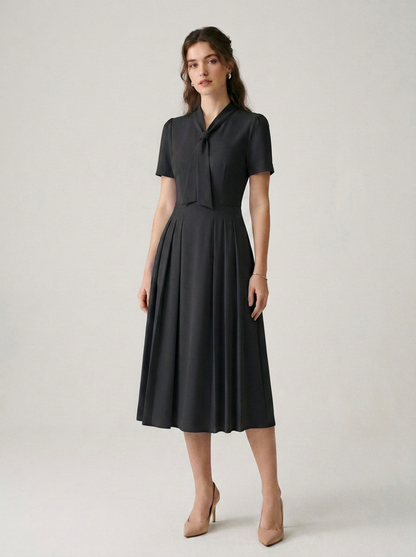 Pleated A-Line Midi Dress with Tie Neckline and Short Sleeves in Black