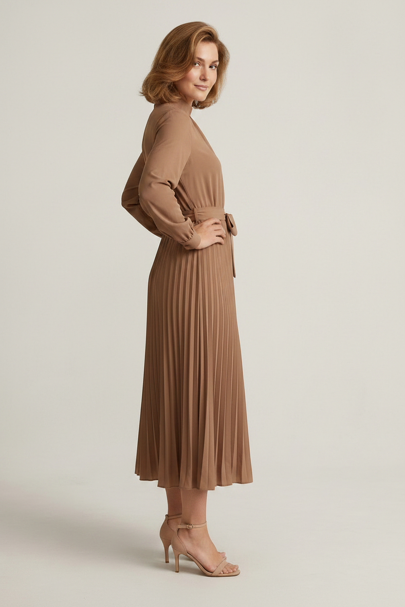 A woman modeling a long-sleeve midi dress in a warm taupe-brown color. The dress features a gathered high neck, a matching fabric tie belt at the waist, and a pleated skirt.