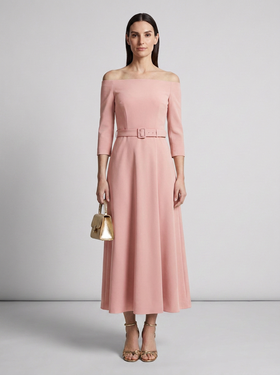 A woman models an off-the-shoulder midi dress in dusty pink with three-quarter sleeves and a matching belt. She is holding a small gold handbag and wearing gold strappy heels, set against a neutral light gray studio background.