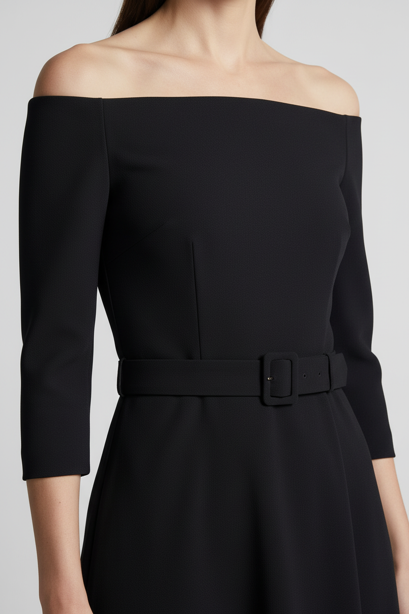 A woman models an off-the-shoulder black midi dress with three-quarter sleeves and a matching belt. She is holding a small metallic gold handbag and wearing gold strappy heels, set against a neutral light gray studio background.